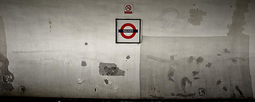 Looking across the platform to the tube sign on the opposite wall, at Balham.