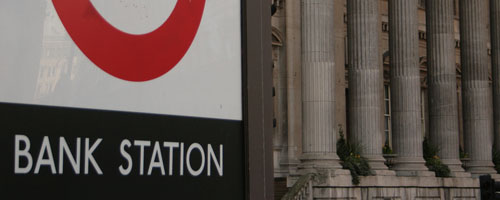 Bank station sign, with the Bank of England in the background.