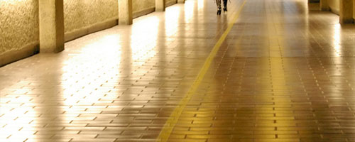 A walkway at the Barbican, with two feet at the top of the frame.