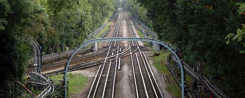 Railway line nearish Buckhurst Hill, with lots of trees.